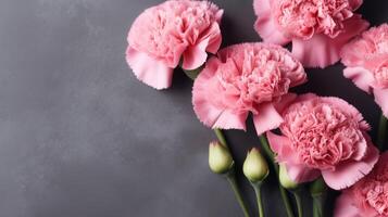 rosado claveles y brotes en un gris manchado antecedentes con Copiar espacio. ai generado. foto