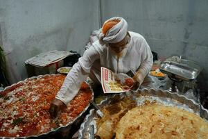 7th April 2023, Zakaria Street, Kolkata, West Bengal, India. Must try item Halwa and Paratha at Zakaria Street during Eid al-Fitr photo