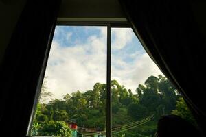 Wide angle view of Mountain from Bed through window of Sikkim Hotel photo