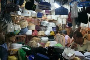 7th April 2023, Zakaria Street, Kolkata, West Bengal, India. Shopkeeper busy in his Prayer Cap shop at Zakaria Street During Ramjan photo