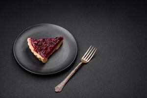 Delicious fragrant sweet pie with cherry berries on a ceramic plate photo