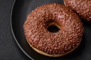 Delicious chocolate glazed donut sprinkled with chocolate chips photo