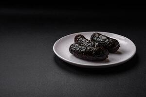 Delicious black blood sausage or black pudding with spices and herbs photo