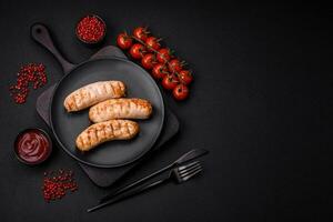 Delicious grilled sausages from chicken or pork meat with salt, spices and herbs photo
