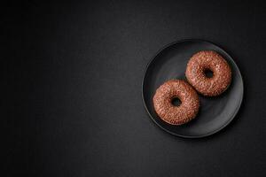 Delicious chocolate glazed donut sprinkled with chocolate chips photo