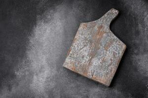 Empty wooden cutting board with cracks and scuffs photo