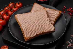 Delicious crispy toast with chicken or goose pate with salt and spices photo