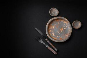 Empty wooden plate, knife, fork and cutting board photo