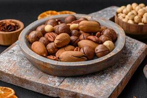 Mix of roasted macadamia nuts, cashews, pecans, almonds, raisins and dry berries photo