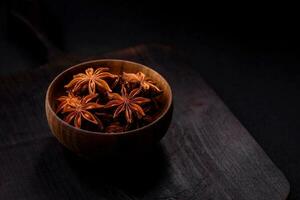 Star shaped spice star anise in a wooden round bowl photo