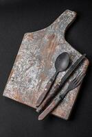 Knife, fork and cutting board, salt, pepper and other ingredients photo