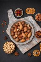 Mix of roasted macadamia nuts, cashews, pecans, almonds, raisins and dry berries photo