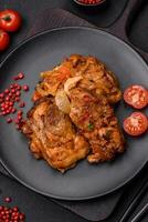 Delicious fried chicken in sauce with onions, salt, spices and herbs photo