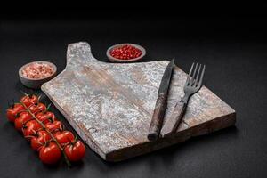 Knife, fork and cutting board, salt, pepper and other ingredients photo