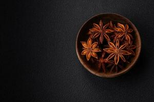 Star shaped spice star anise in a wooden round bowl photo