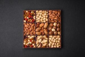 Mix of roasted macadamia nuts, cashews, pecans, almonds, raisins and dry berries photo