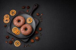 Delicious chocolate glazed donut sprinkled with chocolate chips photo