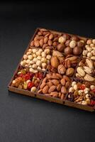 Mix of roasted macadamia nuts, cashews, pecans, almonds, raisins and dry berries photo