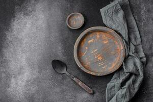 Empty wooden plate, knife, fork and cutting board photo