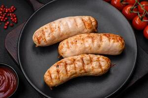 Delicious grilled sausages from chicken or pork meat with salt, spices and herbs photo