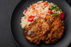 Delicious boiled rice with peppers, peas, asparagus beans and carrots and fried chicken photo