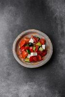 Delicious fresh juicy greek salad with feta cheese, olives, peppers and tomatoes photo