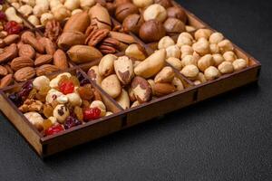 Mix of roasted macadamia nuts, cashews, pecans, almonds, raisins and dry berries photo