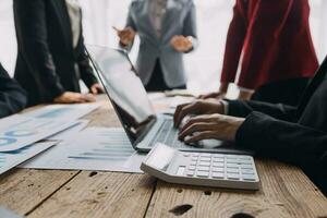 Financial analysts analyze business financial reports on a digital tablet planning investment project during a discussion at a meeting of corporate showing the results of their successful teamwork. photo