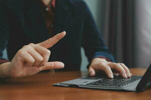 Corporate Communication. Asian Businesswoman Talking On Mobile Phone Working On Laptop In Modern Office. Free Space photo