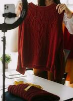 Fashion designer l young asian woman working using laptop, tablet and smiling while standing in workshop Responding on business photo