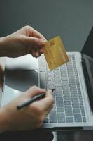 Women holding credit card and using smartphones at home.Online shopping, internet banking, store online, payment, spending money, e-commerce payment at the store, credit card, concept photo