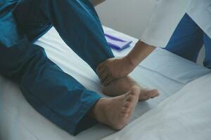 Physiotherapist working with patient in clinic, closeup photo