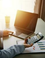 Close up of Business team analyzing income charts and graphs with modern laptop computer. Business analysis and strategy concept. photo