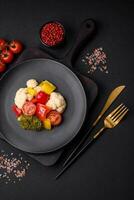 Delicious fresh salad of broccoli, cauliflower, sweet peppers and cherry tomatoes photo