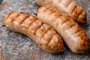 Delicious grilled sausages from chicken or pork meat with salt, spices and herbs photo