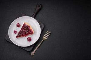 Delicious fragrant sweet pie with cherry berries on a ceramic plate photo