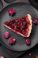 Delicious fragrant sweet pie with cherry berries on a ceramic plate photo