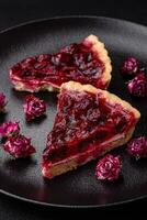 Delicious fragrant sweet pie with cherry berries on a ceramic plate photo