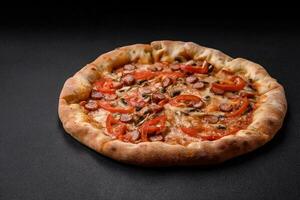 Bavarian pizza with smoked sausages, tomatoes, cheese, salt and spices photo