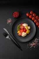 Delicious fresh salad of broccoli, cauliflower, sweet peppers and cherry tomatoes photo