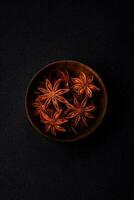 Star shaped spice star anise in a wooden round bowl photo