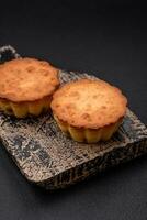 Delicious baked cupcake or tartlet with cheese and raisins photo