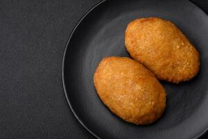 Delicious baked cutlet breaded with spices, salt and herbs photo