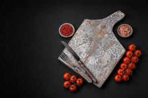 Knife, fork and cutting board, salt, pepper and other ingredients photo