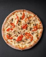 Delicious pizza with chicken, tomatoes and cheese with salt and sauce photo