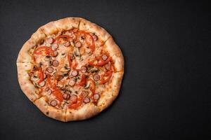 Bavarian pizza with smoked sausages, tomatoes, cheese, salt and spices photo