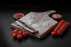 Knife, fork and cutting board, salt, pepper and other ingredients photo