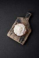 White dry coconut flakes in a wooden bowl prepared for making desserts photo