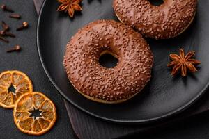 Delicious chocolate glazed donut sprinkled with chocolate chips photo