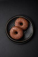 Delicious chocolate glazed donut sprinkled with chocolate chips photo